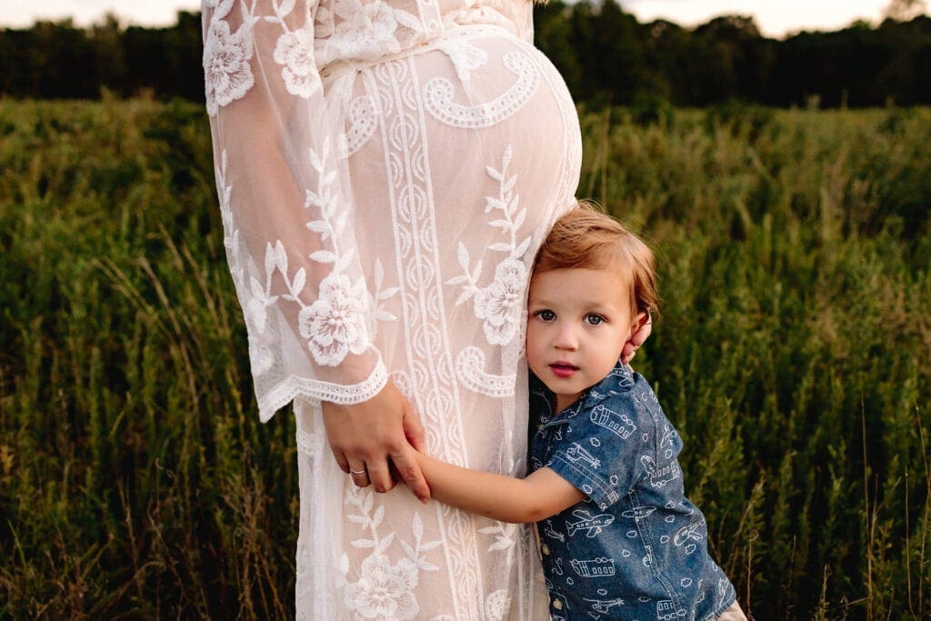 Mom holding toddler boy's hand in a 