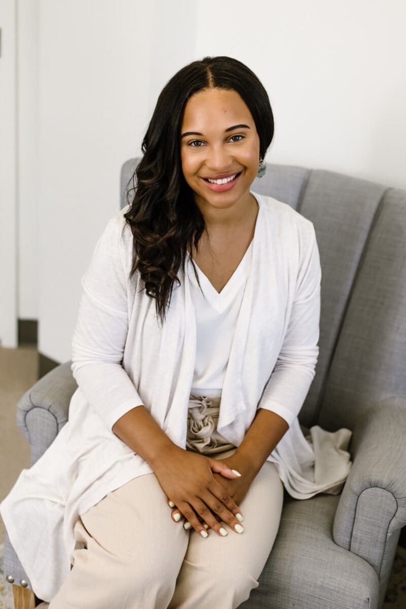 Headshot of Brittany Moffitt sitting on a chair in an office.