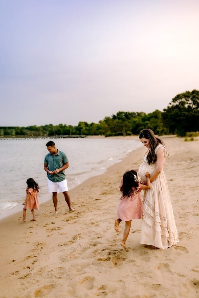 Crofton-Maternity-Photoshoot-3 Family of four plays on the beach in Annapolis, MD.