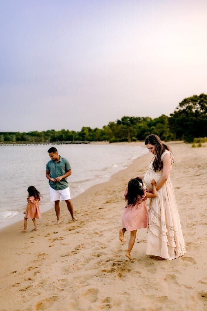 Family of four plays on the beach in Annapolis, MD.