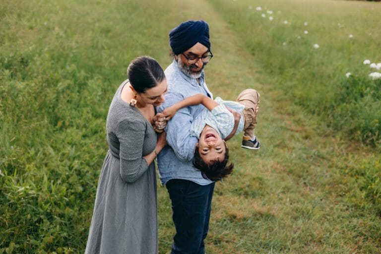 A beautiful day in Schwartz Peony Garden—mom, dad, and their little boy enjoy playful antics, warm snuggles, and delightful laughter at Seneca Creek State Park.