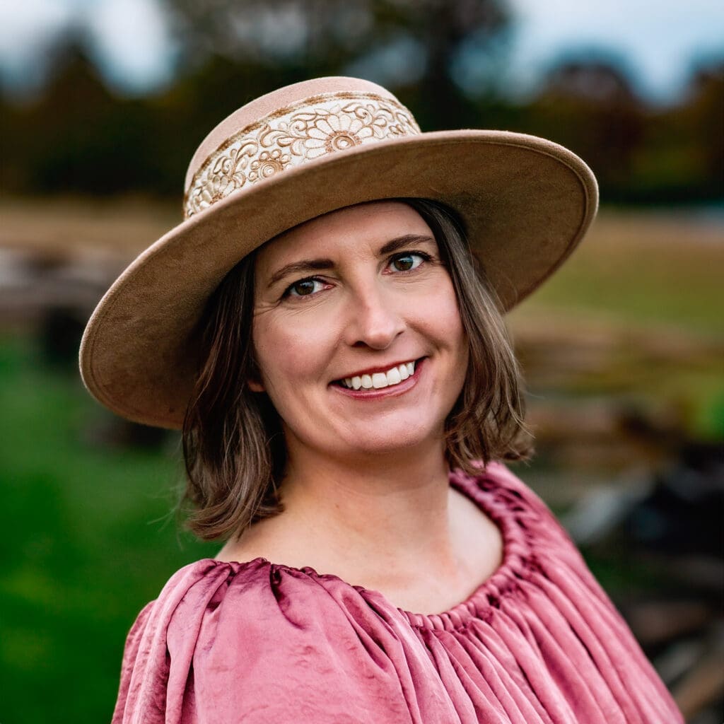 Portrait of Erin Link, Maryland family and maternity photographer, wearing a hat and smiling.