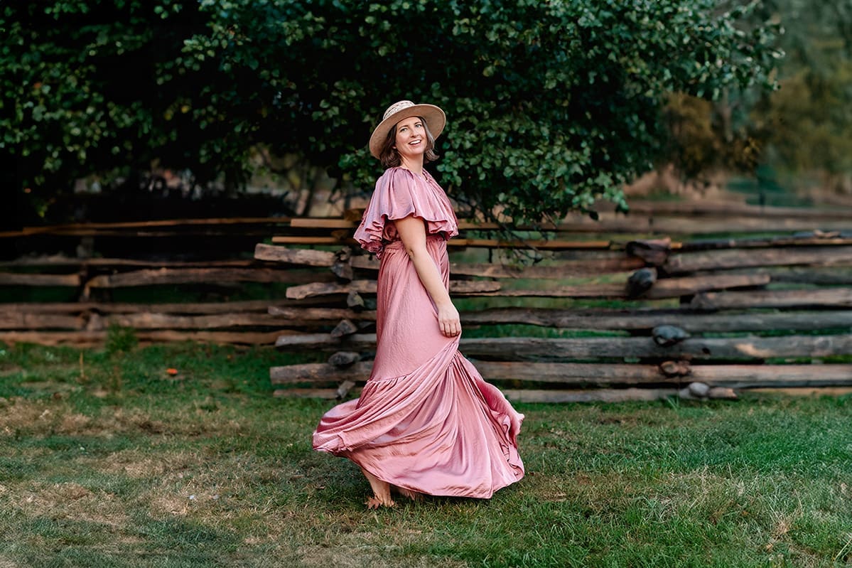 Portrait of Erin Link, Maryland family and maternity photographer, wearing a hat and smiling.