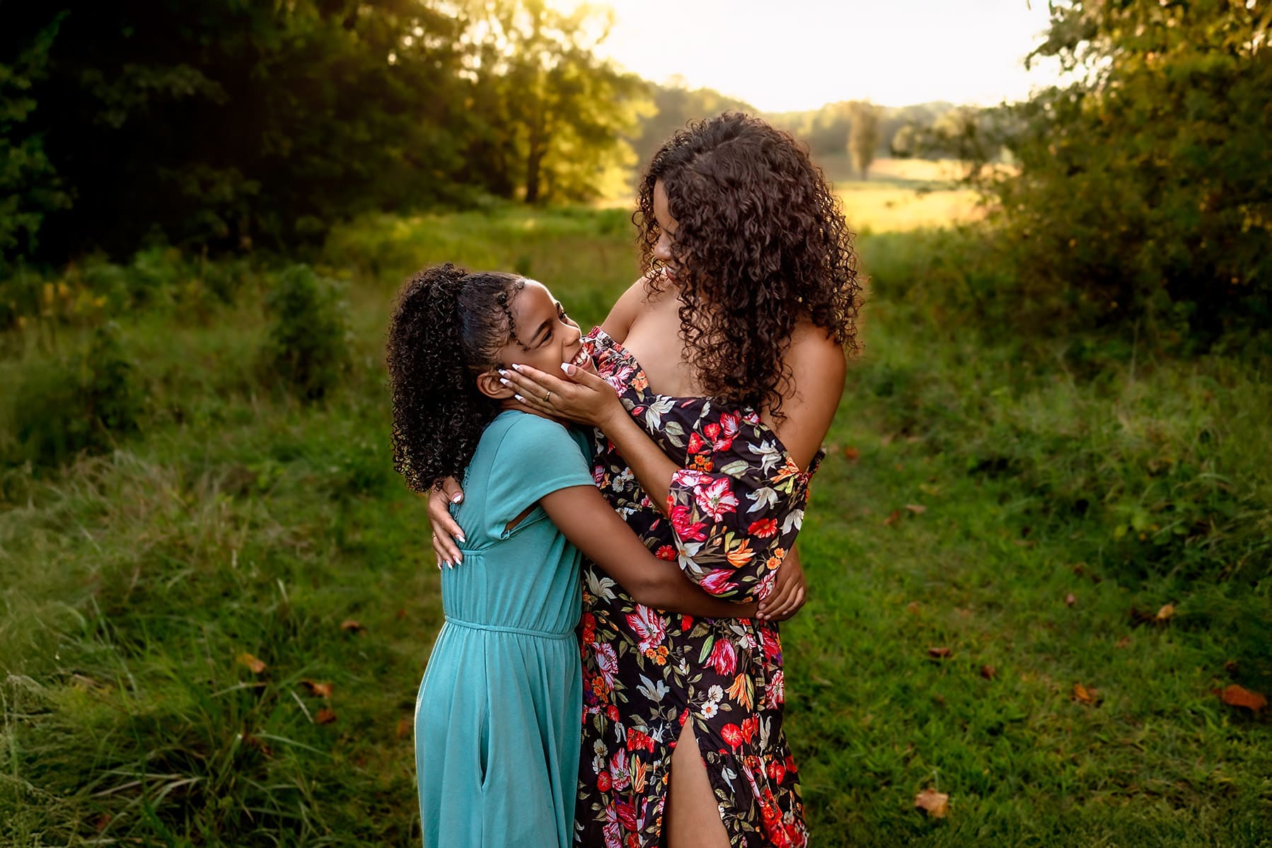 Joyful moment between mother and daughter hugging and smiling during a warm, candid Mothers Day family photo session in Maryland.