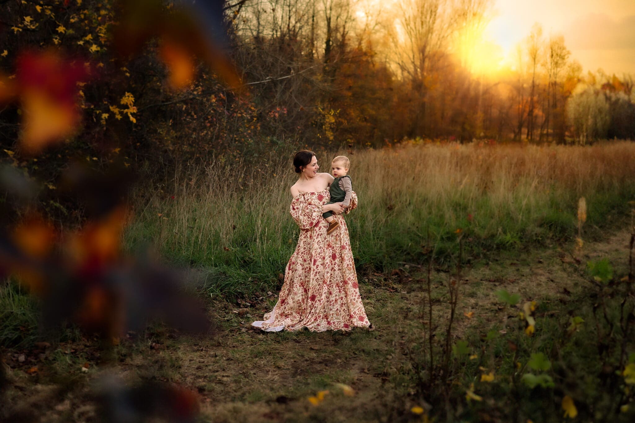 Mother-child photographer Howard County Maryland, mother holding child in a light flowing dress at sunset