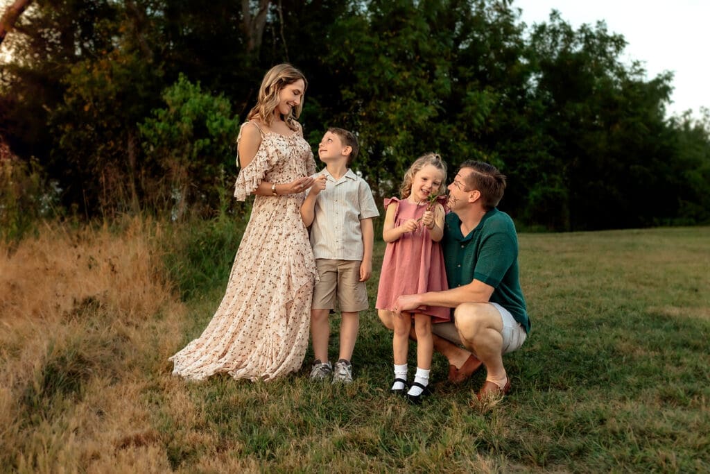 Family of four in a green field near Bowie Maryland, dad kneeling, mother and children in flowing dresses