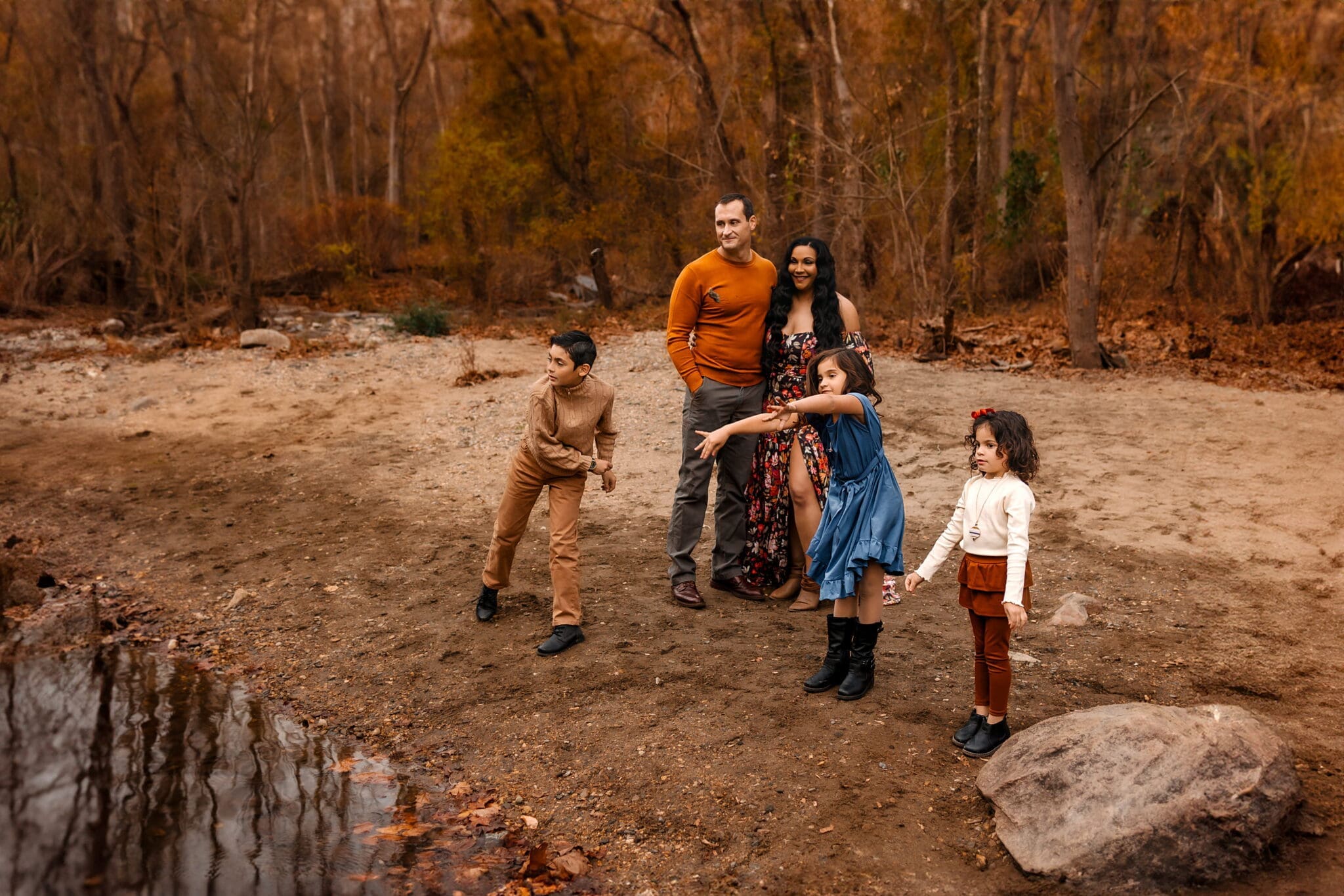 Family of five play along the creek in Hanover, MD