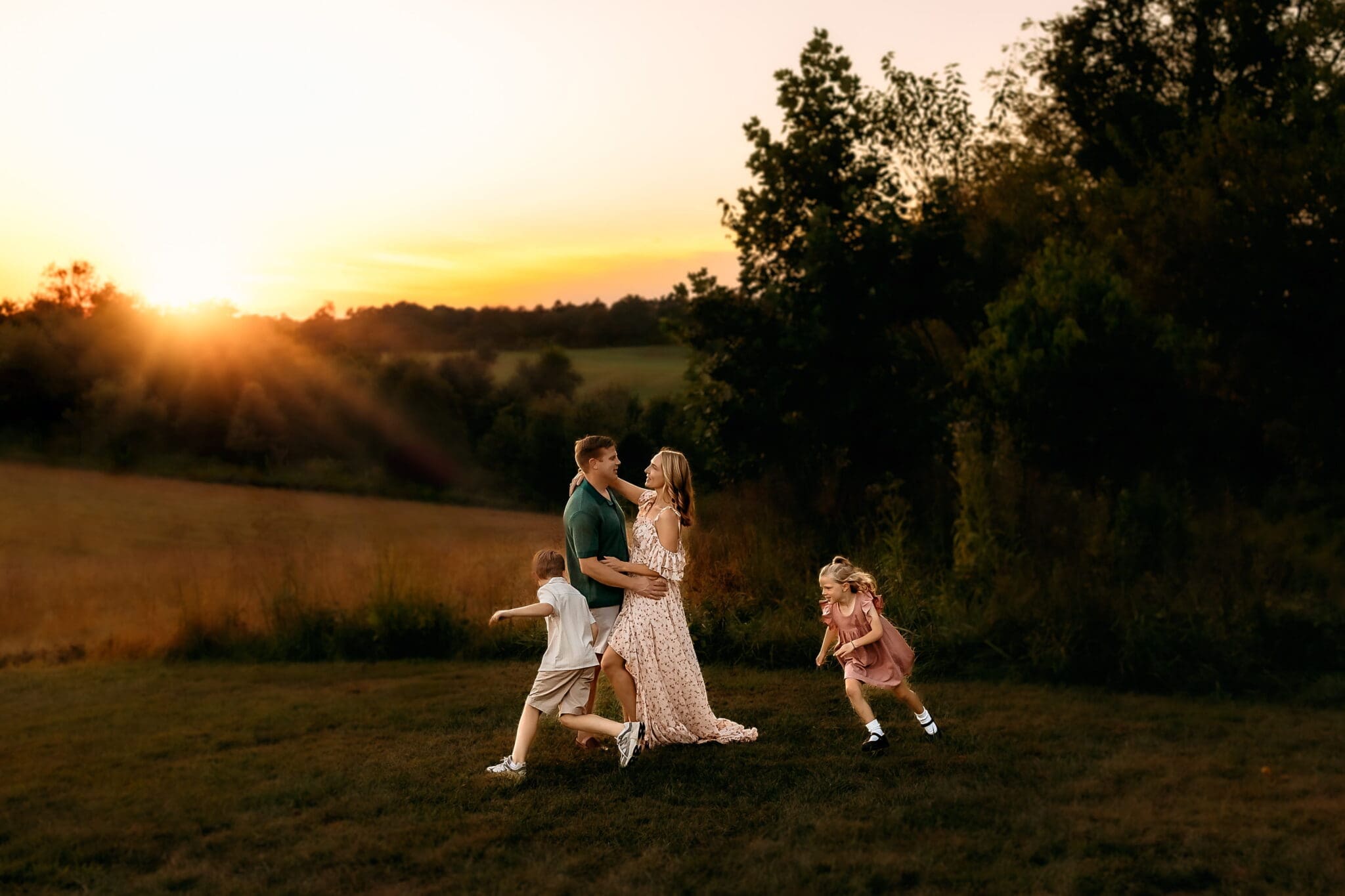 Outdoor family photos Bowie Maryland, family of four at golden sunset in an open field